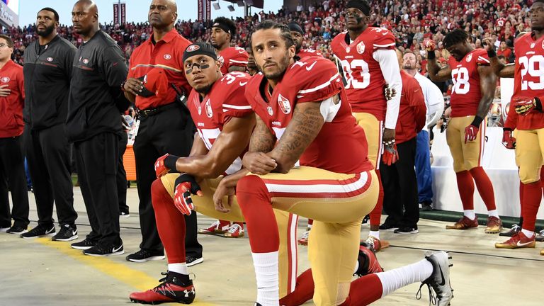 Colin Kaepernick #7 and Eric Reid #35 kneel during the Star Spangled Banner ahead of the win over the Rams