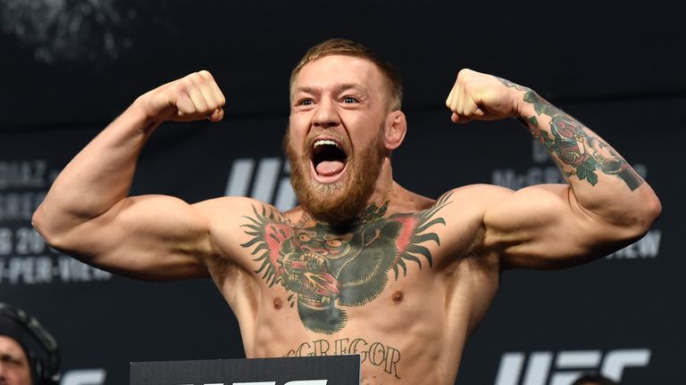 UFC featherweight champion Conor McGregor poses during his weigh-in for UFC 202