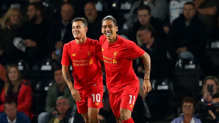 Philippe Coutinho of Liverpool celebrates scoring his team's second goal with Roberto Firmino