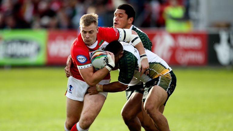 NEATH, WALES - NOVEMBER 10:  Craig Kopczak of Wales is tackled by Rea Pittman (R) of the Cook Islands during the Rugby World Cup Group D match between Wale