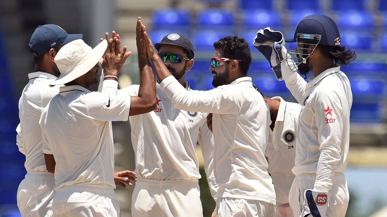 Indian cricketer Ravindra Jadeja (2nd-R) celebrates with teammates after dismissing WICB President's XI squad batsman Vishaul Singh during the three-day to