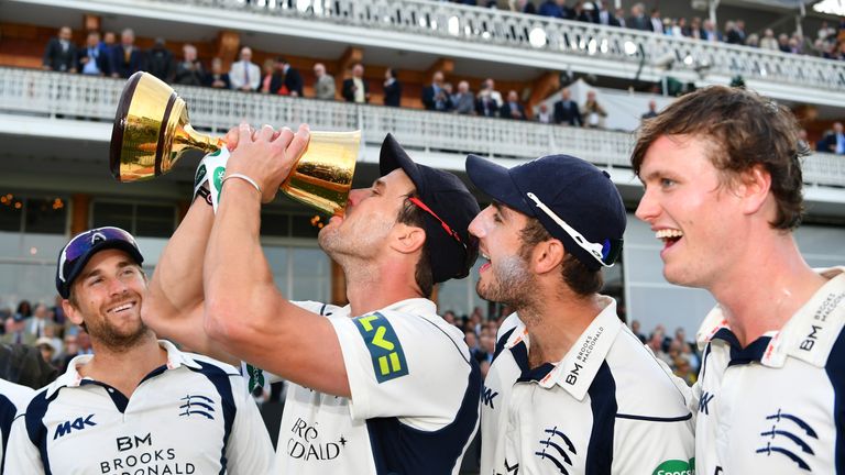 Nick Compton of Middlesex drinks champagne from the County Championship Trophy 