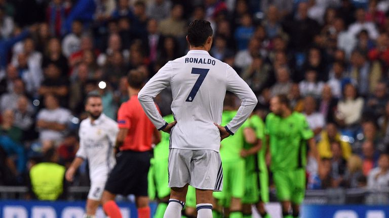 Real Madrid's Cristiano Ronaldo stands dejected as Sporting players celebrate their opening goal