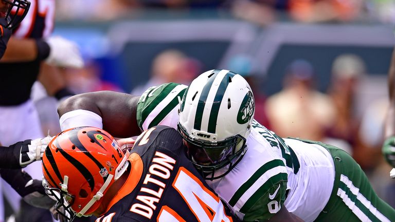 EAST RUTHERFORD, NJ - SEPTEMBER 11:  Andy Dalton #14 of the Cincinnati Bengals is sacked by Muhammad Wilkerson #96 of the New York Jets at MetLife Stadium 