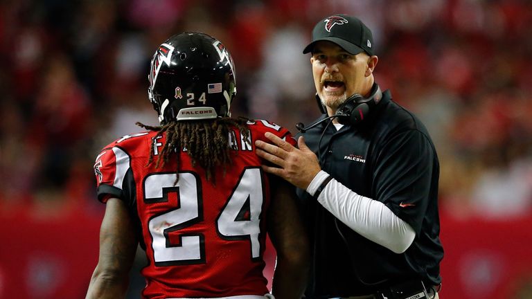 ATLANTA, GA - OCTOBER 04: Devonta Freeman #24 celebrates with head coach Dan Quinn of the Atlanta Falcons after a touchdown in the second half against the 