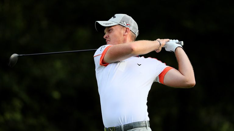 Danny Willett of England hits his second shot on the 1st hole during the third round of the Italian Open 
