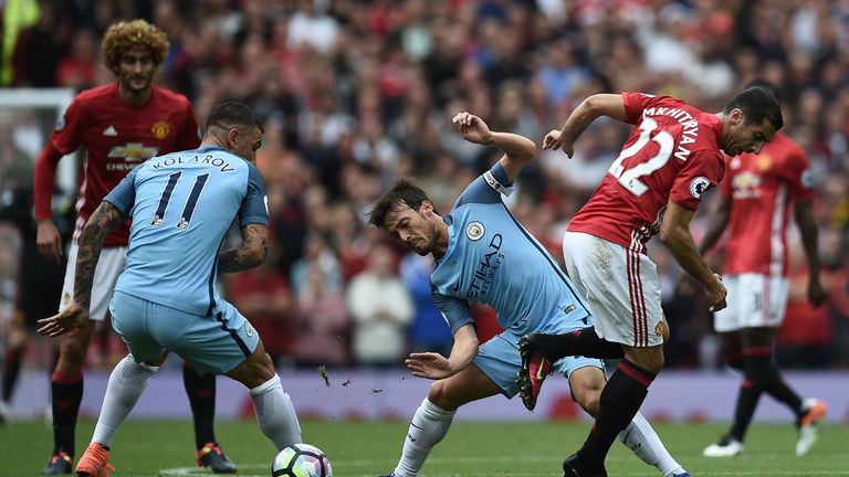 Manchester United's Armenian midfielder Henrikh Mkhitaryan (R) vies with Manchester City's Serbian defender Aleksandar Kolarov