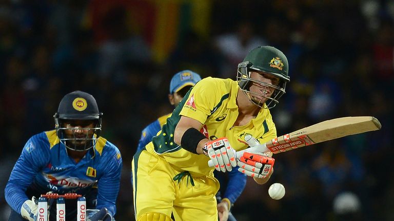 Australia's David Warner (R) is watched by Sri Lanka's wicketkeeper Kusal Perera (L) as he plays a shot during the fifth and final one day international (O