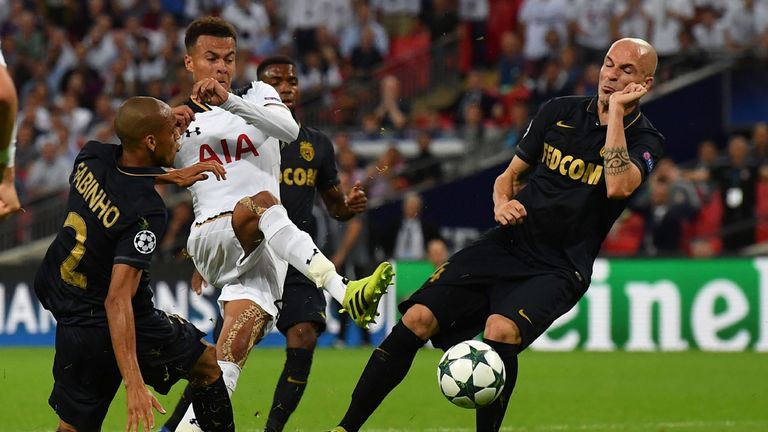 Tottenham Hotspur's English midfielder Dele Alli (C) shoots past Monaco's Brazilian defender Fabinho (L) during the UEFA Champions League group E football 