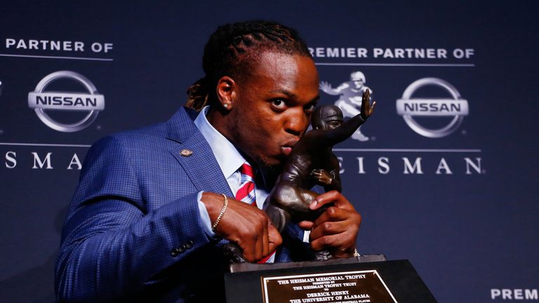 NEW YORK, NY - DECEMBER 12:  Running back Derrick Henry of the Alabama Crimson Tide kisses the Heisman Trophy during a press conference after being named t