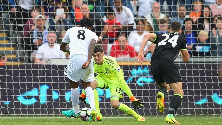 SWANSEA, WALES - SEPTEMBER 11:  Leroy Fer of Swansea City (8) beats goalkeeper Thibaut Courtois and Gary Cahill of Chelsea (24) as he scores their second g