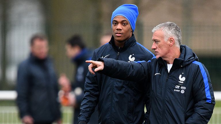 France head coach Didier Deschamps (R) speaks with forward Anthony Martial during a training session in Clairefontaine-en-Yvelines