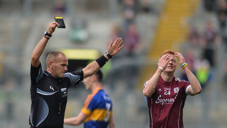 Adrian Varley of Galway is shown a black card by referee Conor Lane