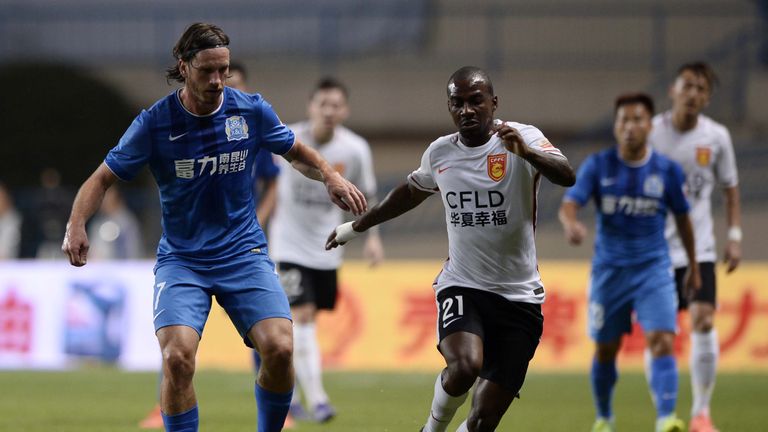 Gael Kakuta (R) of Hebei CFFC competes for the ball with Anders Svensson of Guangzhou R&F during their Chinese Super League football match in March 2016