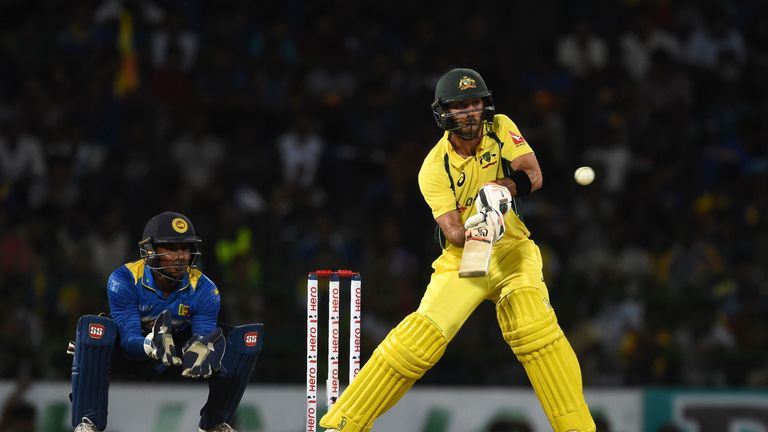 Australia's Glenn Maxwell hits a shot as Sri Lankan's Kusal Perera (R) looks on during the final T20 international against Sri Lanka