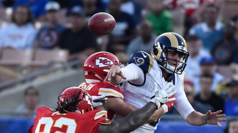 LOS ANGELES, CA - AUGUST 20:  Quarterback Jared Goff #16 (R) of the Los Angeles Rams is sacked in the second quarter by Daniel Sorensen #49 of the Kansas C