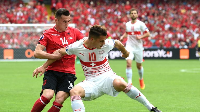 Switzerland's midfielder Granit Xhaka (R) challenges his brother Albania's midfielder Taulant Xhaka (L) during the Euro 2016 group A football match between