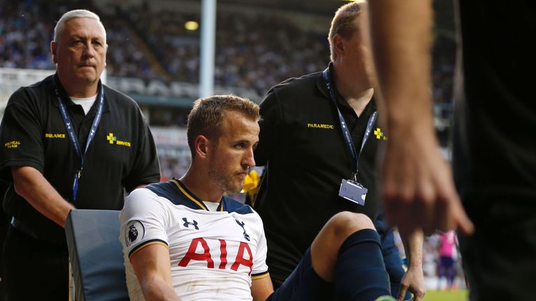 Tottenham striker Harry Kane is wheeled away on a stretcher after leaving the pitch injured 