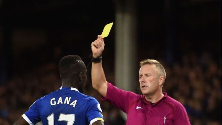 Jon Moss issues Everton midfielder Idrissa Gueye with a yellow card at Goodison Park
