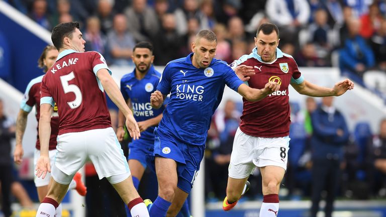 Islam Slimani of Leicester (C) takes the ball past Michael Keane of Burnley during the Premier League clash