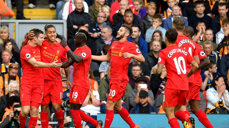 James Milner (L) celebrates scoring Liverpool's second goal of the game