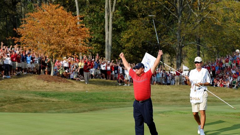 LOUISVILLE, KY - SEPTEMBER 21:  J.B. Holmes of the USA team (L) celebrates alongside his caddie (R) after completing his singles matches on the final day o