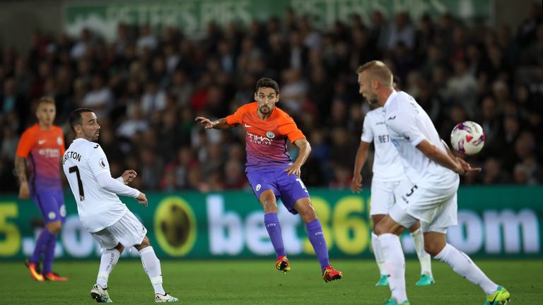 Manchester City's Jesus Navas (centre) takes a shot during the EFL Cup, Third Round match at the Liberty Stadium, Swansea.