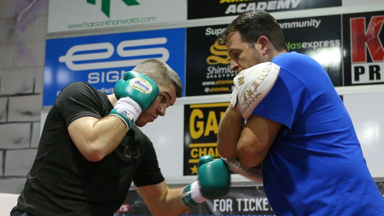 BOLTON, ENGLAND - DECEMBER 14: Liam Smith with trainer Joe Gallagher during a media work-out at the Gloves Community Centre on December 14, 2015 in Bolton,
