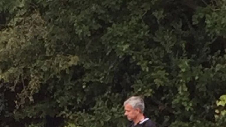 Jose Mourinho watches his Manchester United squad train in a hotel car park