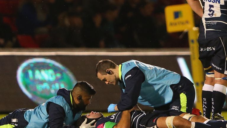 SALFORD, ENGLAND - SEPTEMBER 09:  Josh Beaumont of Sale Sharks lies injured after being tackled by Mat Luamanu of Harlequins during the Aviva Premiership m