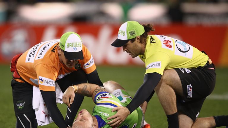 Josh Hodgson of the Raiders receives attention from a trainer