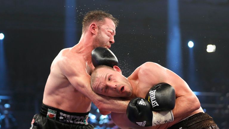 Juergen Braehmer (L) of Germany exchanges punches with Enzo Maccarinelli