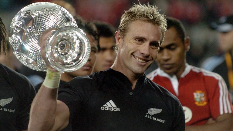 Justin Marshall holds the DHL series trophy following the third and final rugby test won by the All Blacks against the British and Irish Lions .