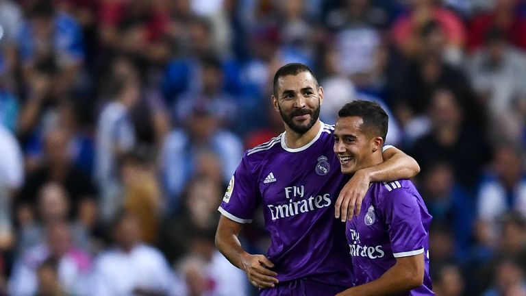 Karim Benzema (L) celebrates with his team mate Lucas Vazquez of Real Madrid after scoring his team's second goal
