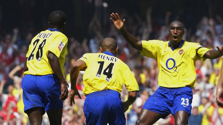 Kolo Toure and Sol Campbell celebrate with Thierry Henry at the start of the 2003 season