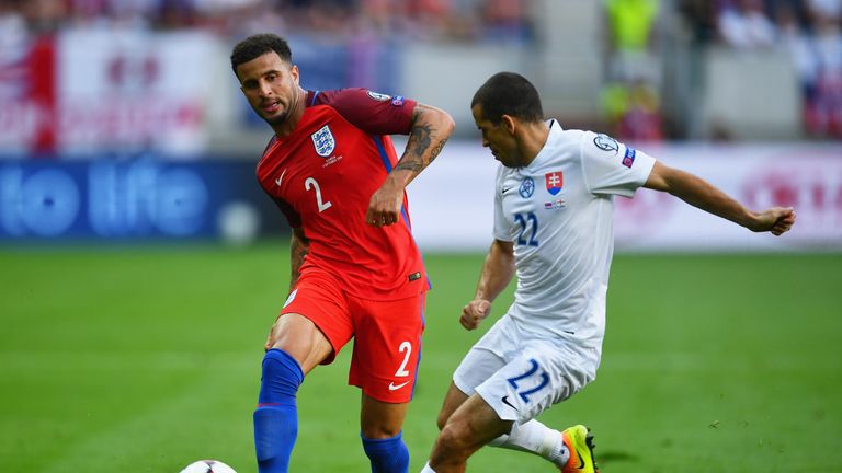 Kyle Walker of England is faced by Viktor Pecovsky of Slovakia