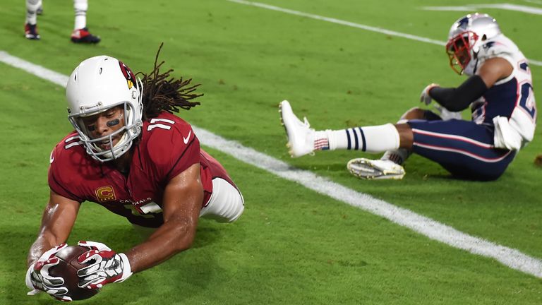 GLENDALE, AZ - SEPTEMBER 11:  Wide receiver Larry Fitzgerald #11 of the Arizona Cardinals dives in front of cornerback Logan Ryan #26 of the New England Pa