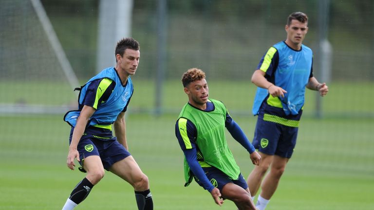 Laurent Koscielny (left) shadows Alex Oxlade-Chamberlain in training on the eve of Arsenal's game at PSG