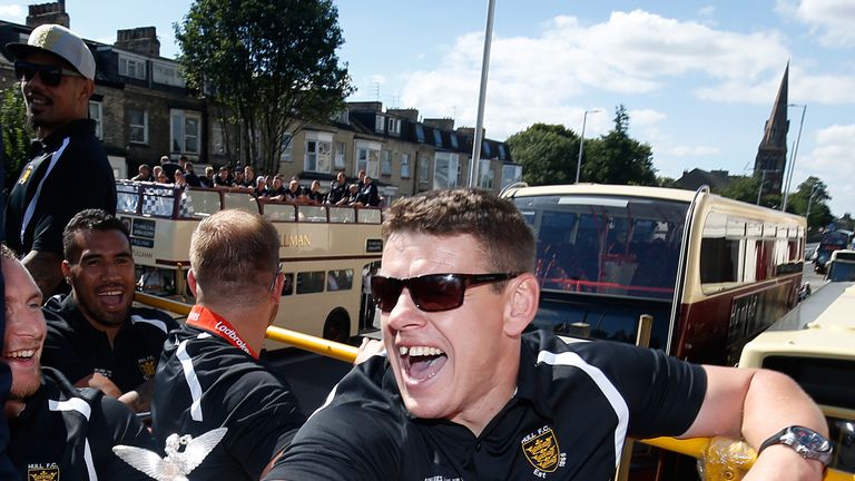 Hull FC coach Lee Radford with the Challenge Cup trophy during the open top bus tour parade through Hull City Centre.