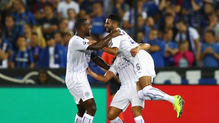 Riyad Mahrez of Leicester City celebrates with team-mates Wes Morgan and Daniel Drinkwater 