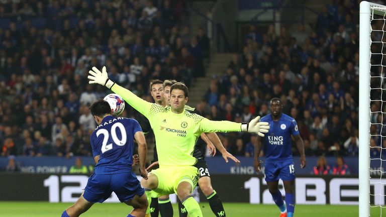 Shinji Okazaki of Leicester City scores the opening goal past Asmir Begovic of Chelsea