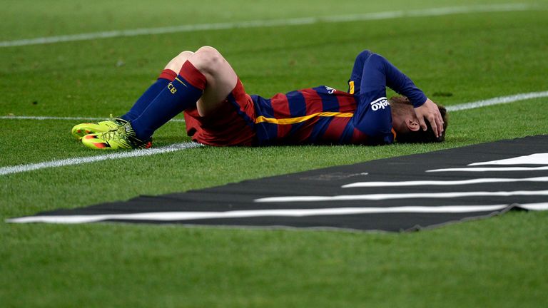 Barcelona's Argentinian forward Lionel Messi lies on the field after being hit during the Spanish "Copa del Rey" (King's Cup) final match FC Barcelona vs S