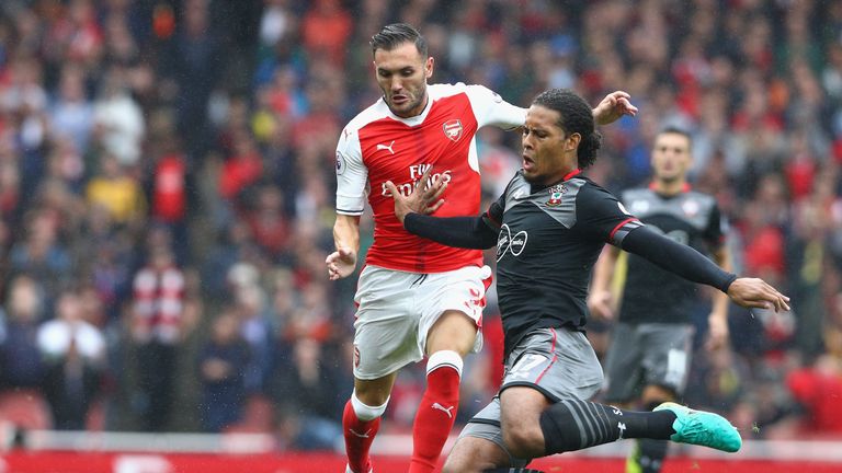  Virgil van Dijk tackles Lucas Perez during the Premier League match between Arsenal and Southampton