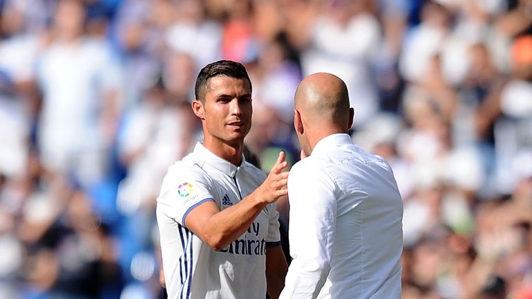 Cristiano Ronaldo shakes hands with Real manager Zinedine Zidane after being substituted against Osasuna