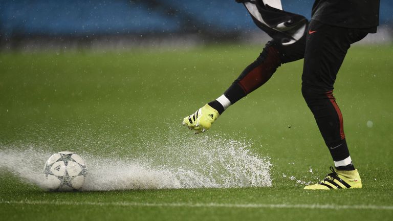 Manchester City's Argentinian goalkeeper Willy Caballero kicks a ball on the waterlogged pitch 