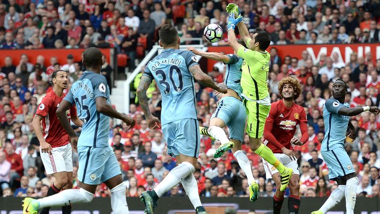 Claudio Bravo (3rd R) fumbles the ball as he collides with team-mate John Stones 