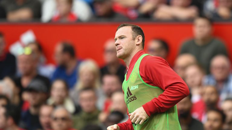 Wayne Rooney warms up on the touchline at Old Trafford