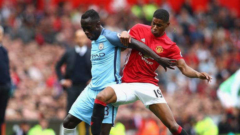 Marcus Rashford gets stuck in on Bacary Sagna after coming off the bench during the Manchester derby