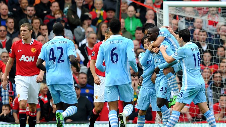 MANCHESTER, ENGLAND - OCTOBER 23:  Mario Balotelli of Manchester City is congratulated by his team mates after scoring the opening goal during the Barclays