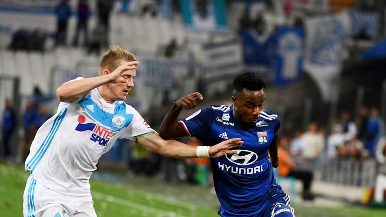 Lyon's French forward Maxwel Cornet (R) vies with Olympique de Marseille's Czech defender Tomas Hubocan  during their French L1 football match Olympique of